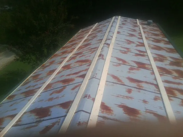 Rusted metal roof panels with new wood purlins before replacement — Storm Damage Roof Repair in Saratoga by Roofing Brothers